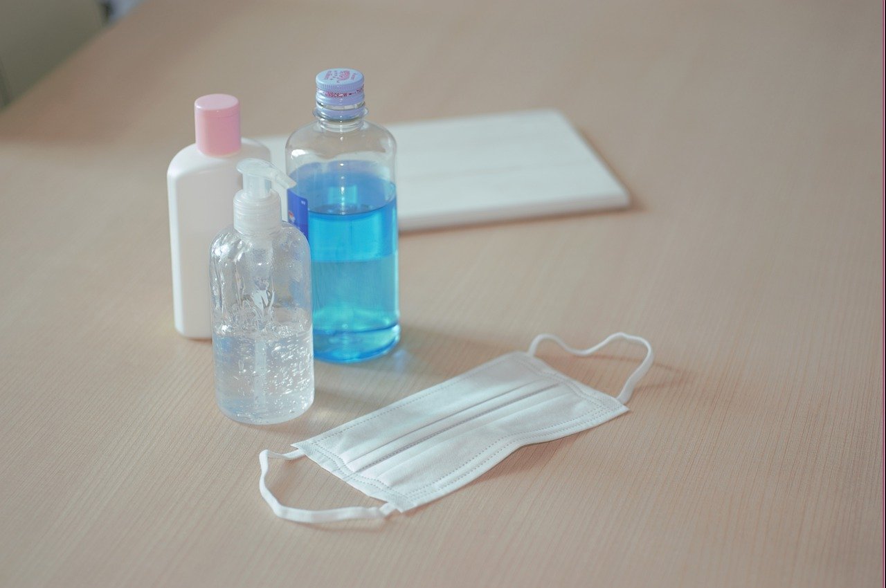 hand sanitizer and mask on table