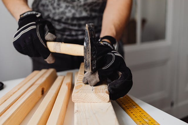 maintenance-personel-hammering-nail